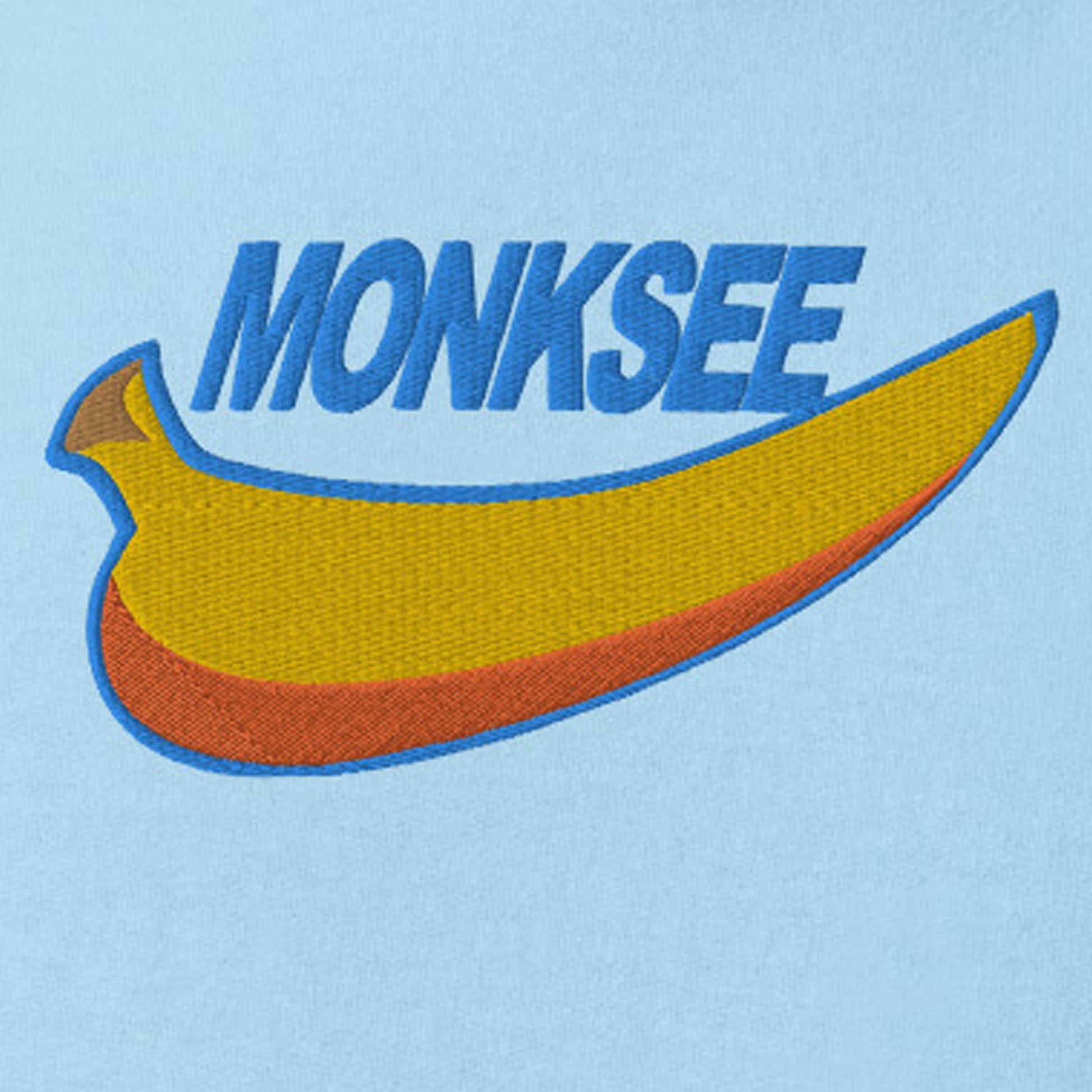 Close up of Monksee just blew it wording and banana on midweight hoodie