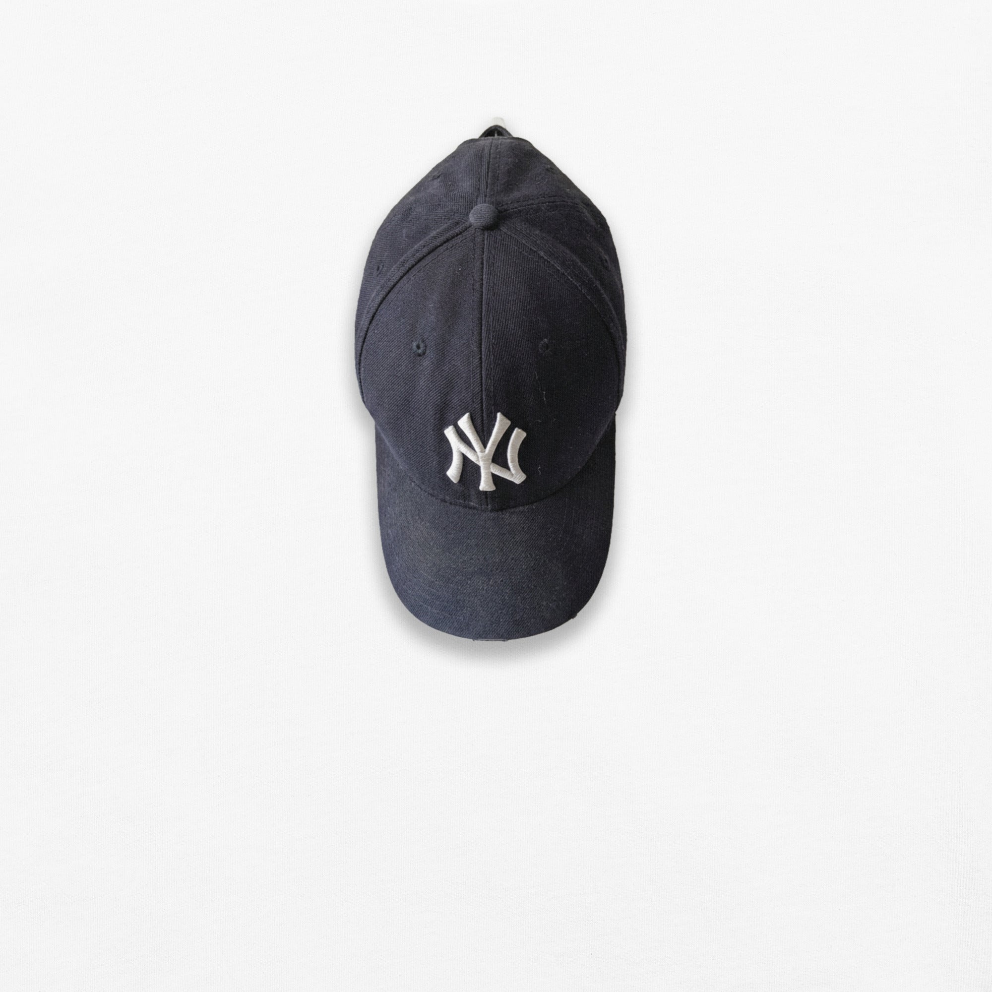 Blue NY baseball cap with a logo on a white background