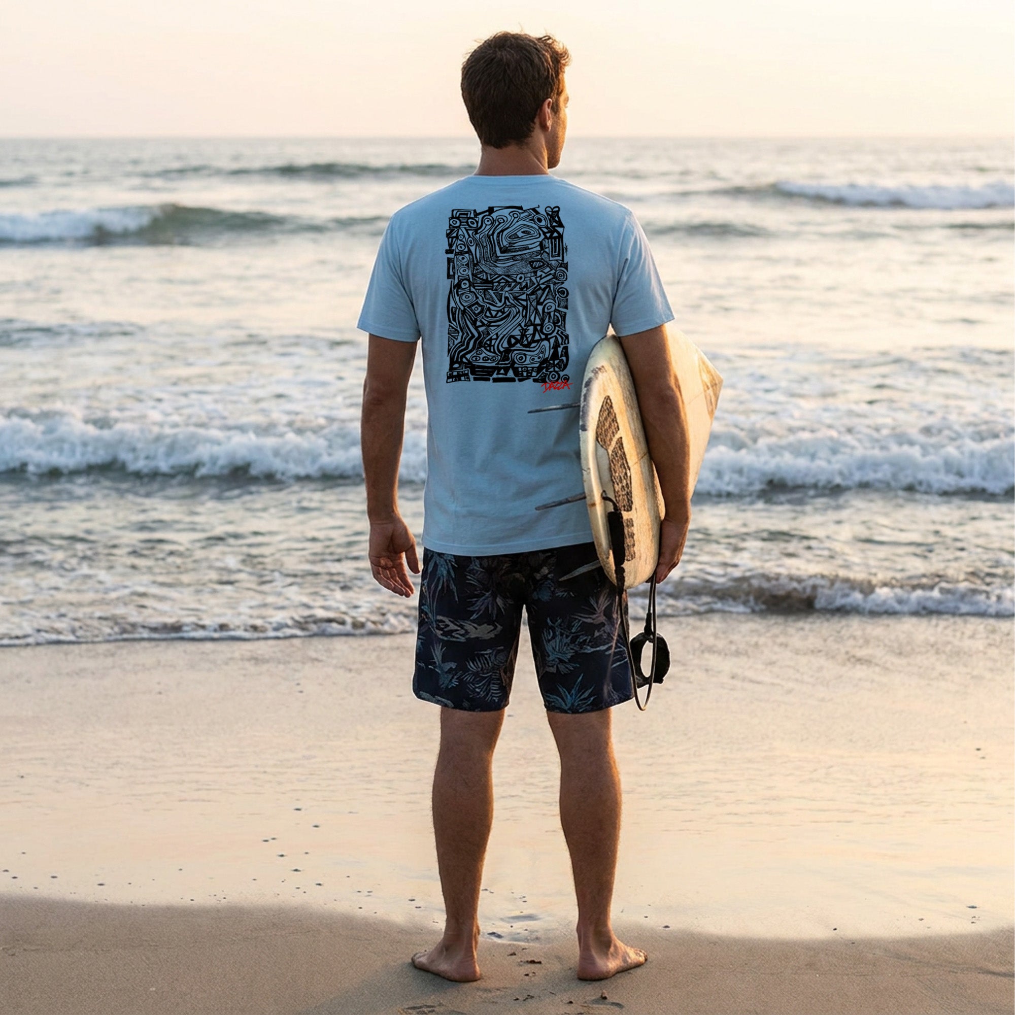 surfer standing on the beach wearing Dazza 001 t-shirt