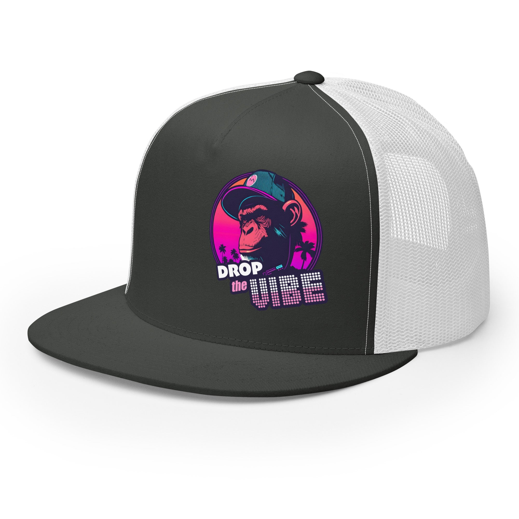 A charcoal and white Monksee "Drop the Vibe" trucker cap with a mesh back, displayed flat against a white background, showing front and left side. The front features a graphic of a cap-wearing monkey against a sunset with palm trees, with "DROP the VIBE" in bold pink and white text below it. The back has a plain mesh panel with a snapback closure.
