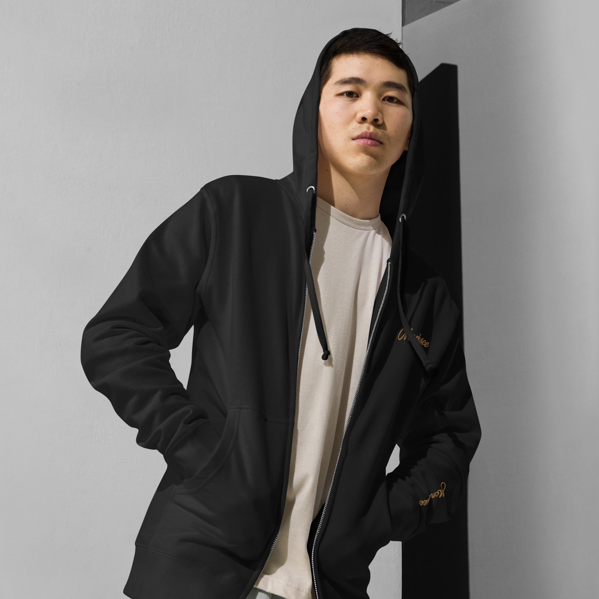 Man wearing black Gold Digger fleece zip up hoodie.