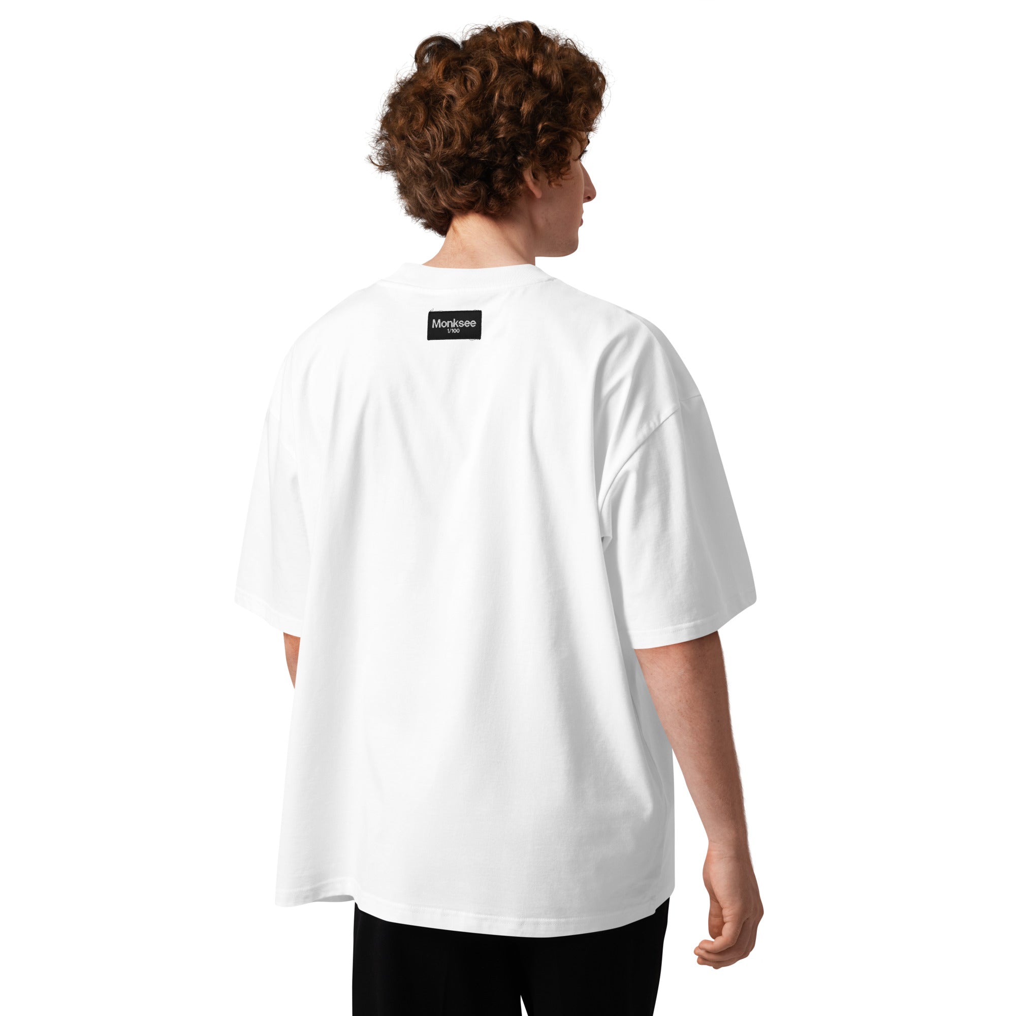 Person wearing a white t-shirt with a Monksee label on the back, standing against a white background