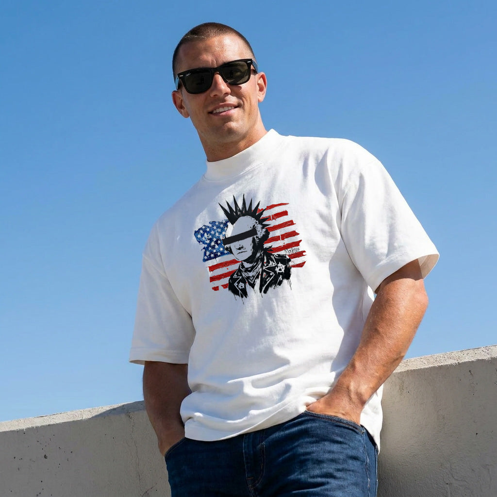 Man wearing a white Monksee Punk Republic t-shirt with a graphic design against a clear blue sky.