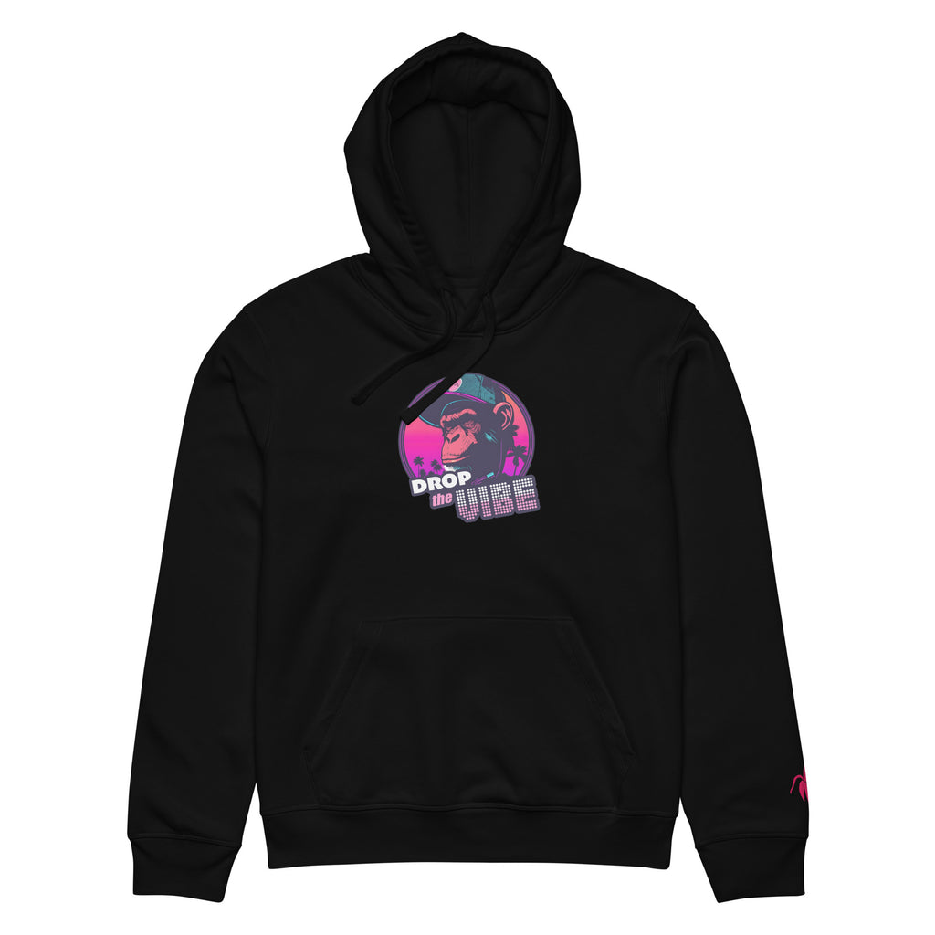 A black Monksee "Drop the Vibe" hoodie up displayed flat against a white background. It features a neon graphic of a cap-wearing monkey against a sunset with palm trees, with "DROP the VIBE" in bold pink and white text. A small pink embroidered Monksee banana logo is on the left sleeve