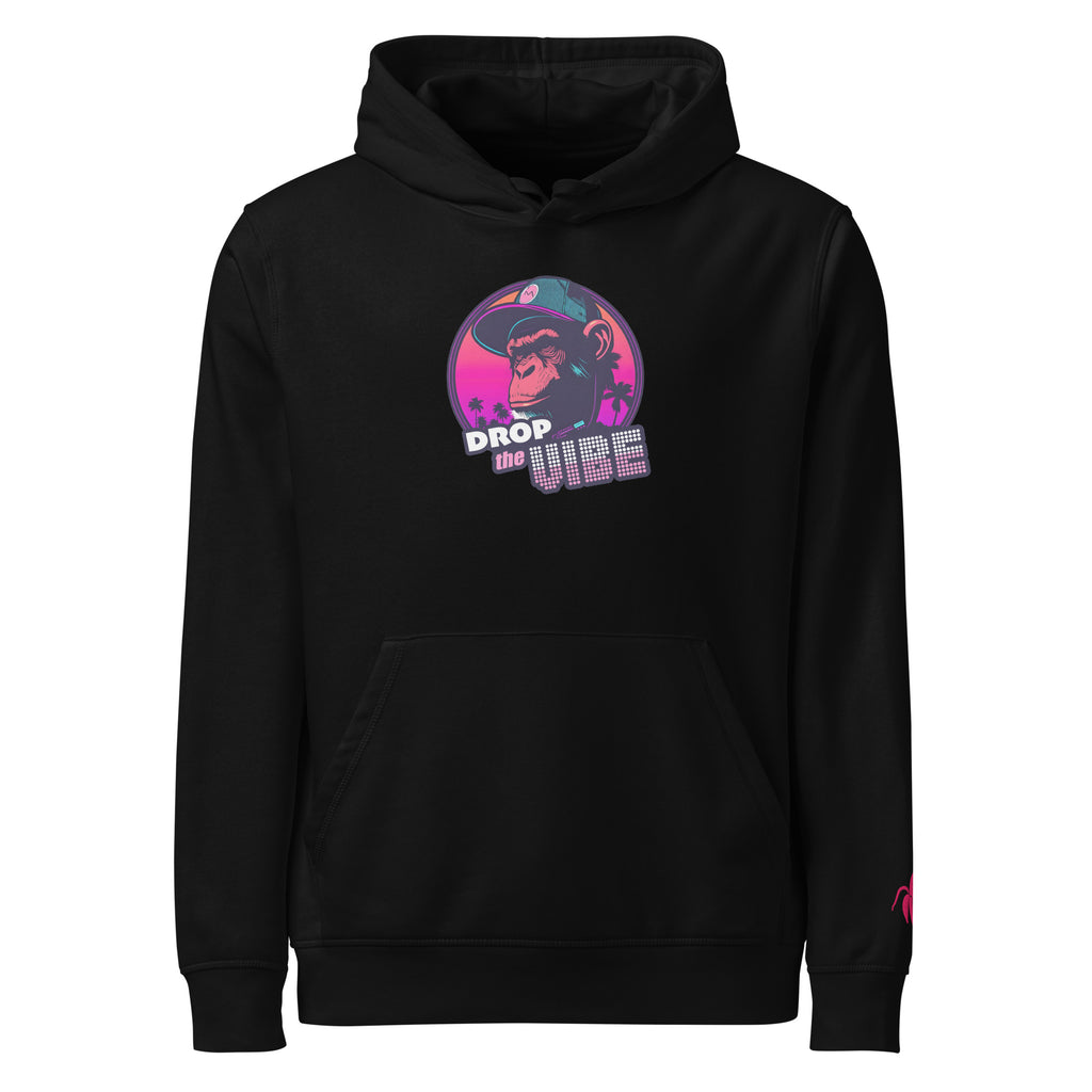 A black Monksee "Drop the Vibe" hoodie displayed flat against a white background. It features a neon graphic of a cap-wearing monkey against a sunset with palm trees, with "DROP the VIBE" in bold pink and white text. A small pink Monksee banana logo is on the left sleeve.