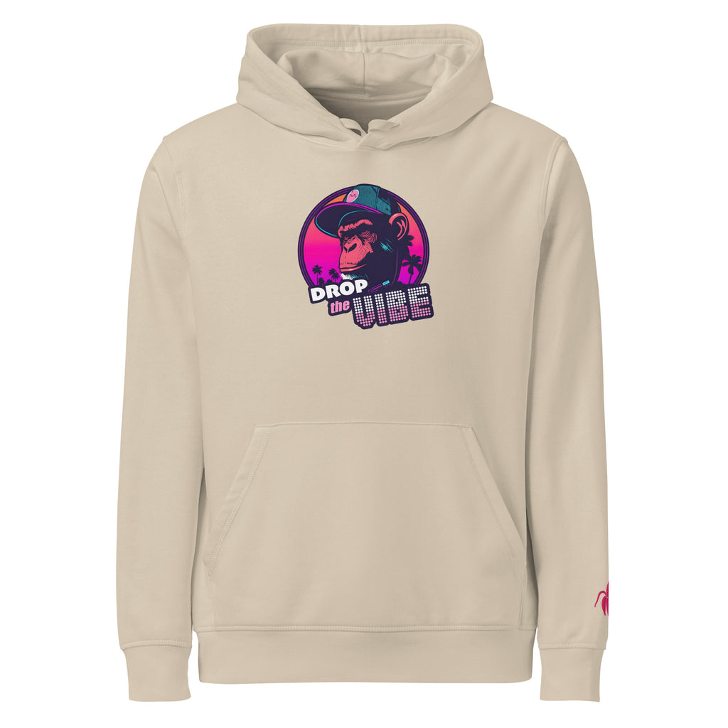A desert Monksee "Drop the Vibe" hoodie displayed flat against a white background. It features a neon graphic of a cap-wearing monkey against a sunset with palm trees, with "DROP the VIBE" in bold pink and white text. A small pink Monksee banana logo is on the left sleeve.