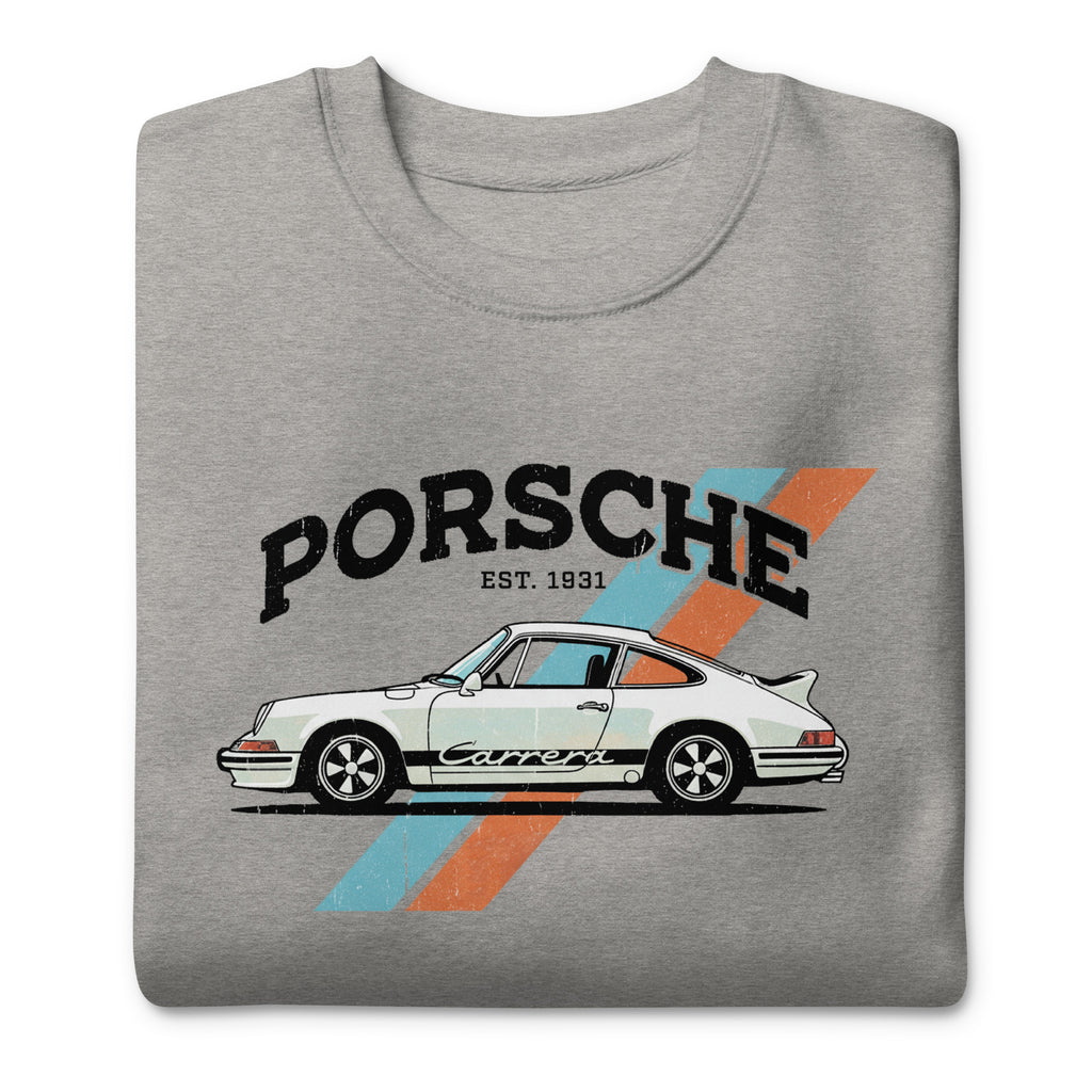 A folded heather gray t-shirt featuring a vintage-style graphic of a white Porsche 911 with the text 'PORSCHE EST. 1931' and a blue and orange diagonal stripe design.