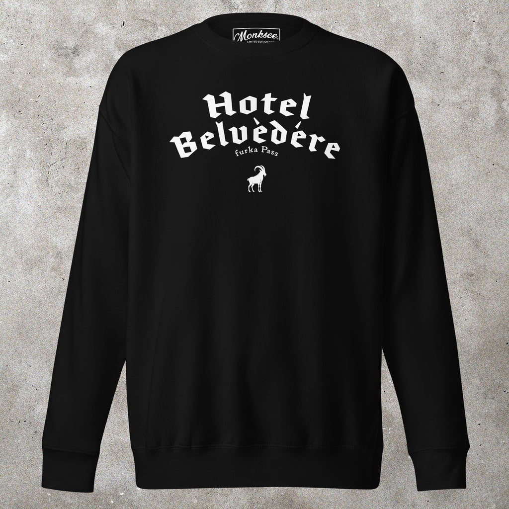 Black sweatshirt with 'Hotel Belvedere' text on a concrete surface