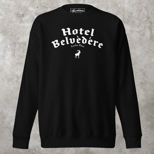 Black sweatshirt with 'Hotel Belvedere' text on a concrete surface