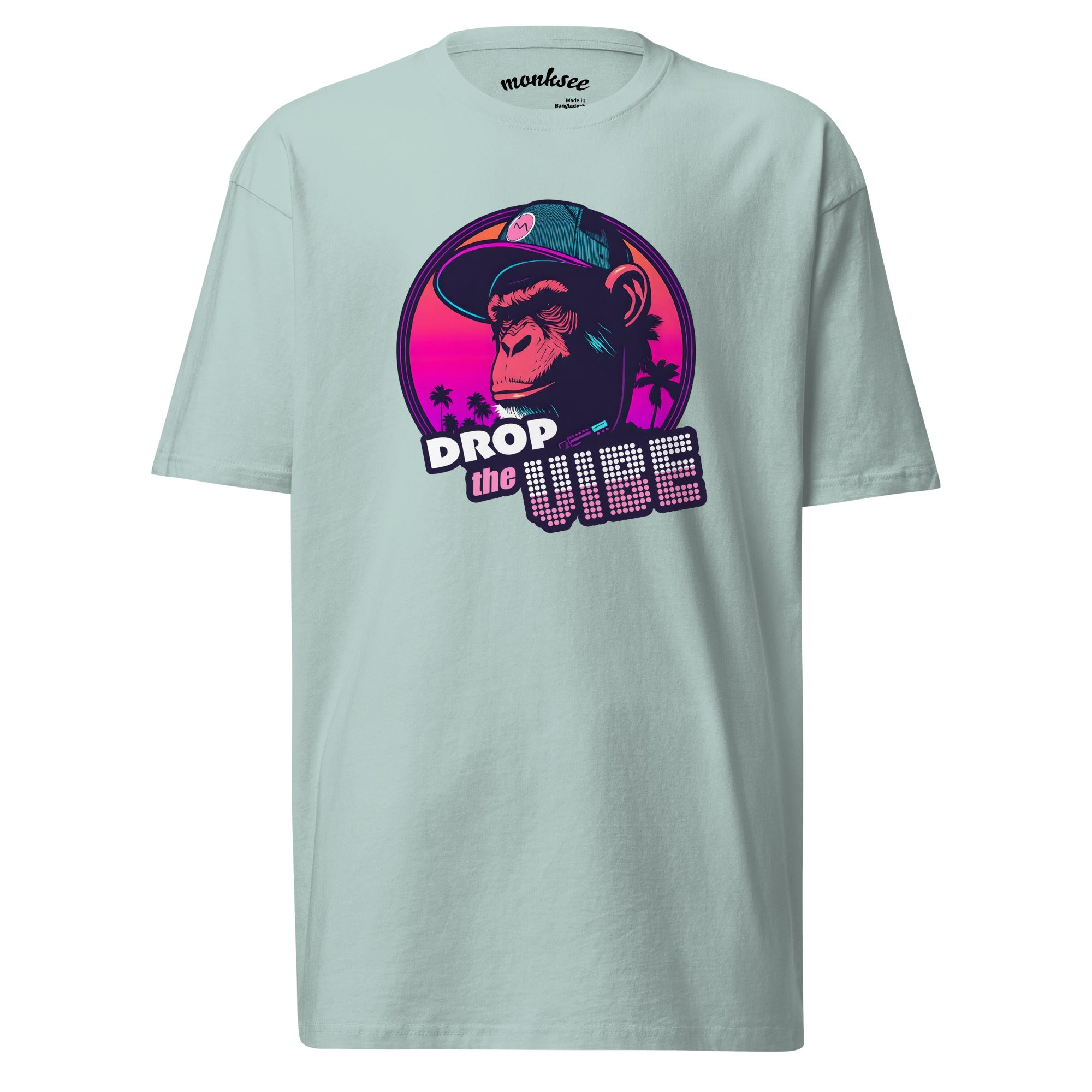 agave Monksee "Drop the Vibe" t-shirt displayed flat against a white background. It features a neon graphic of a cap-wearing monkey against a sunset with palm trees, with "DROP the VIBE" in bold pink and white text. The Monksee banana is on the back neck