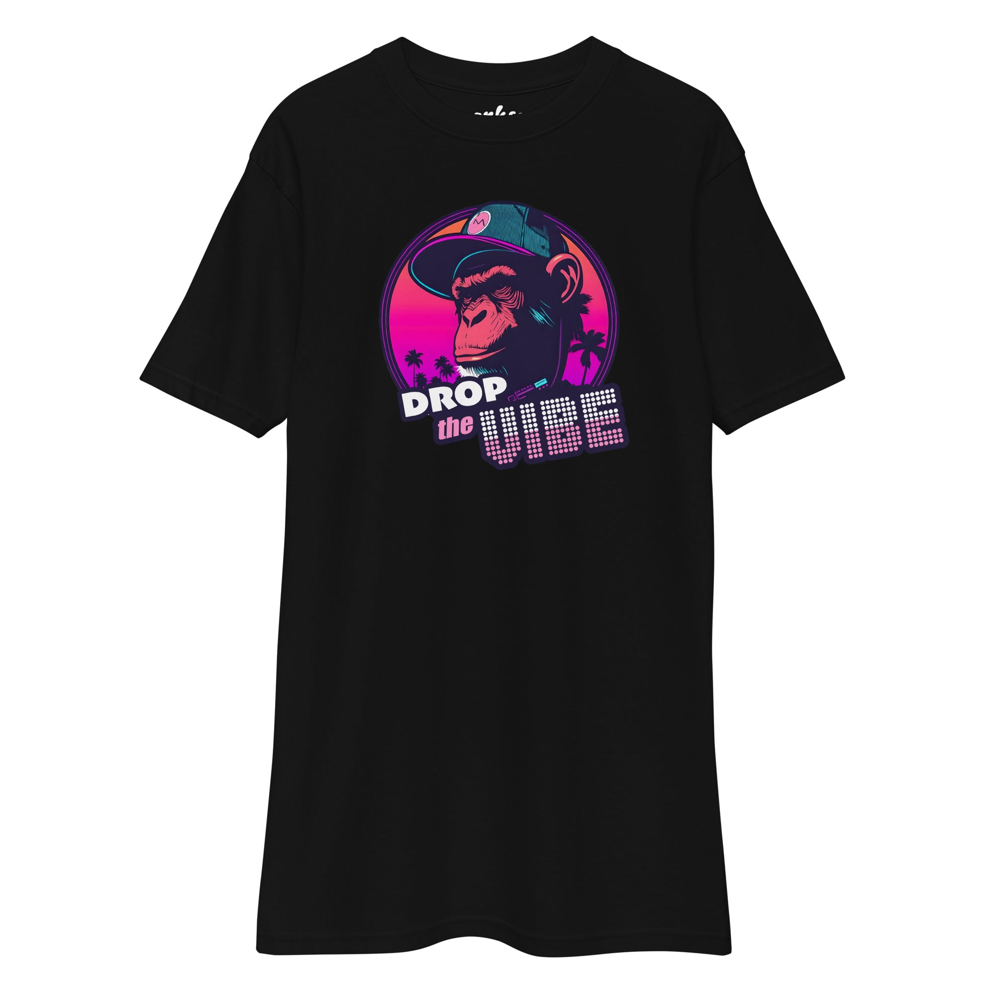 black wrinkled Monksee "Drop the Vibe" t-shirt displayed flat against a white background. It features a neon graphic of a cap-wearing monkey against a sunset with palm trees, with "DROP the VIBE" in bold pink and white text.
