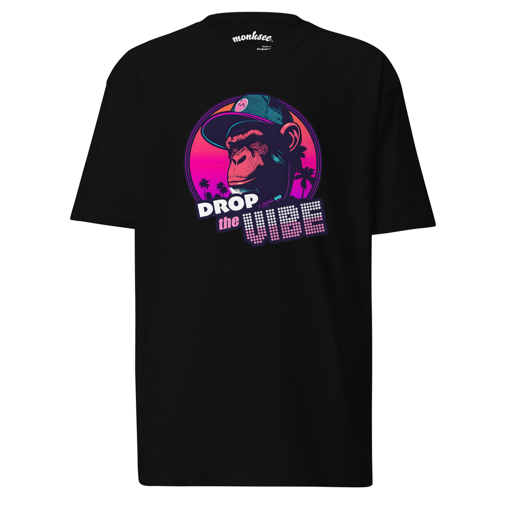 A black Monksee "Drop the Vibe" t-shirt displayed flat against a white background. It features a neon graphic of a cap-wearing monkey against a sunset with palm trees, with "DROP the VIBE" in bold pink and white text. The Monksee banana is on the back neck.