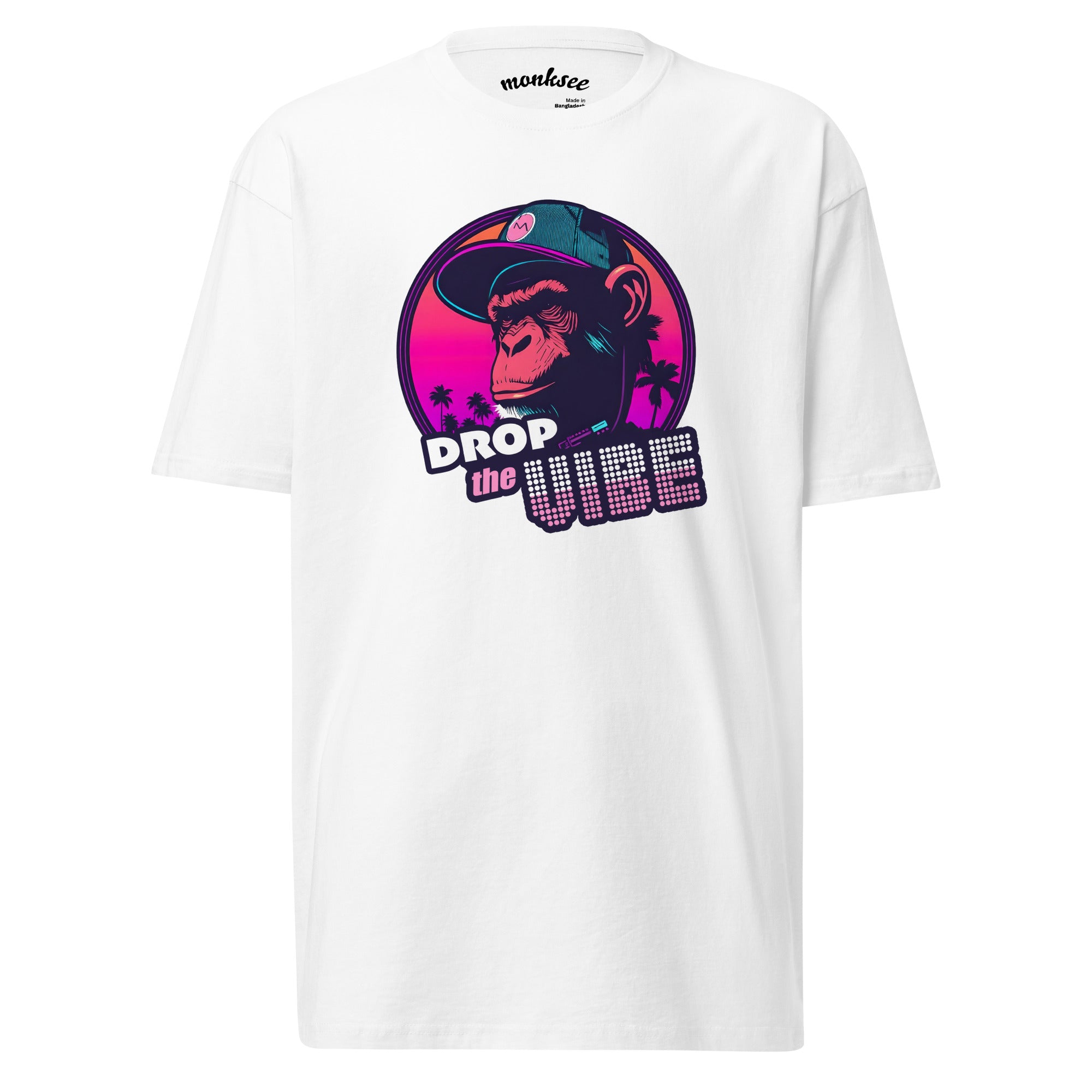 white Monksee "Drop the Vibe" t-shirt displayed flat against a white background. It features a neon graphic of a cap-wearing monkey against a sunset with palm trees, with "DROP the VIBE" in bold pink and white text. The Monksee banana is on the back neck