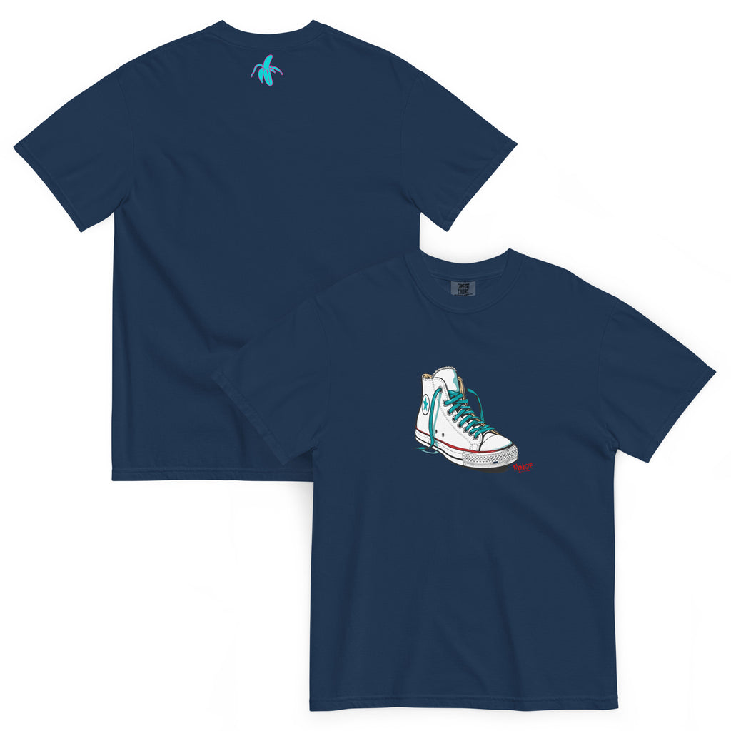 an image of the front and back of the monksee kickin it navy tshirt featuring artistic drawing of a chuck Taylor Allstars shoe on the front and the teal and pink monksee banana on the back