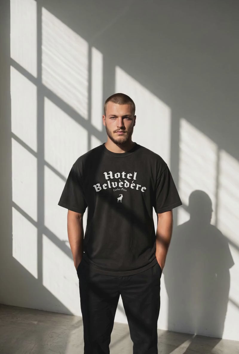 video of guy trying on black Monksee Hotel Belvedere t-shirt